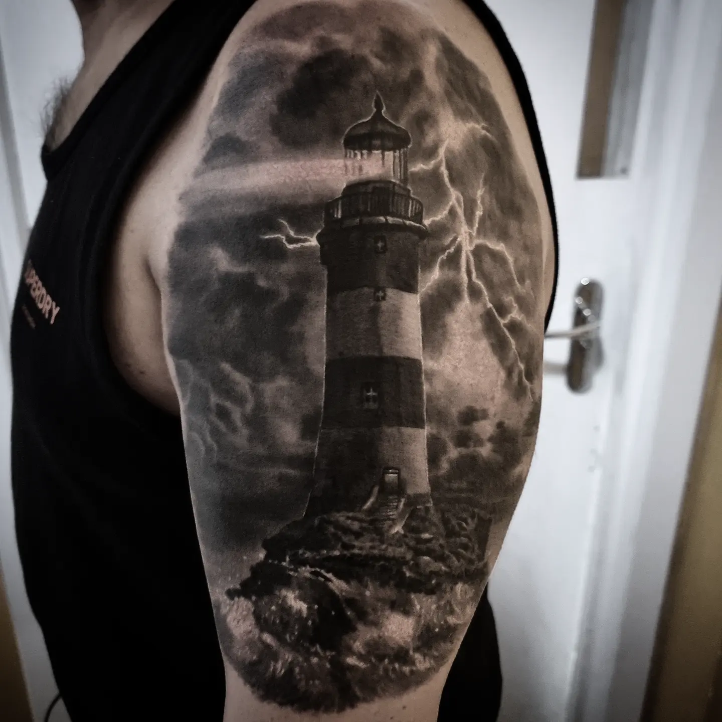 Realistic black and grey landscape tattoo by Tomek Turlej at Studio XIII Gallery Edinburgh